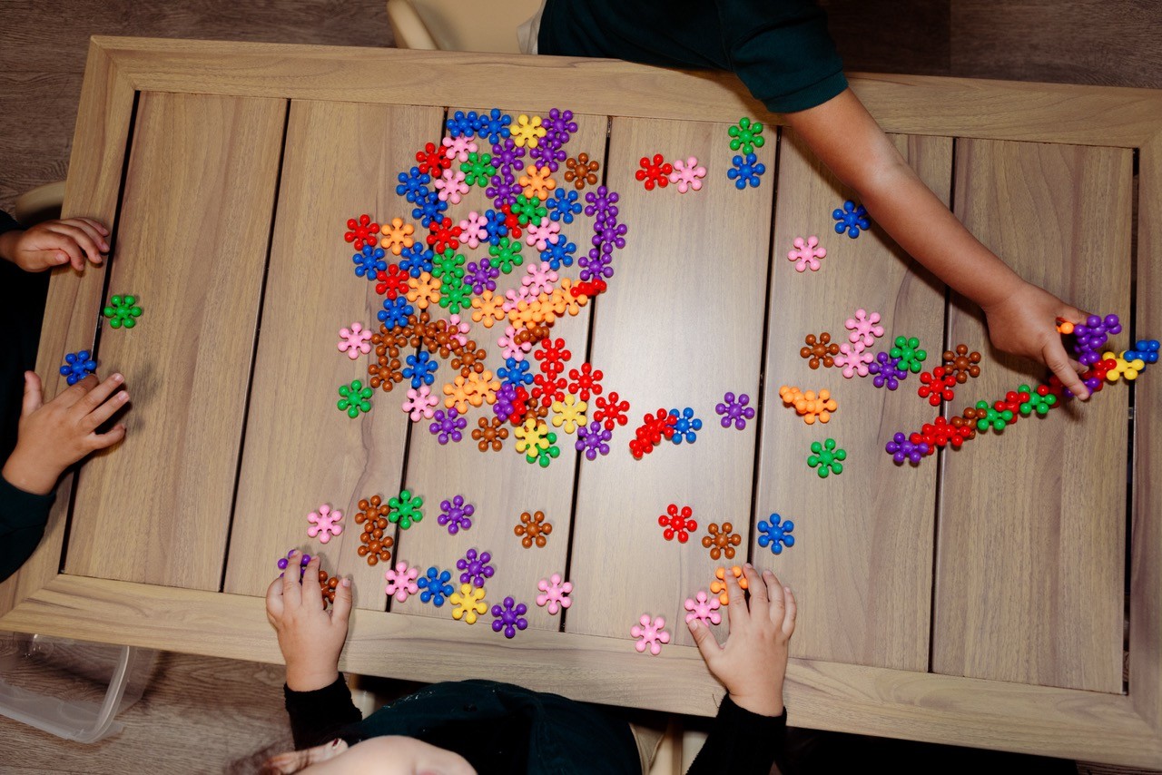 Children playing with colored sorting tools